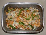 Chicken quarters and carrots buried under wild mushrooms - ready for oven